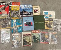 All 18 railroad books and magazines laid out on concrete floor