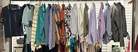 Full rack view showing approximately 20 assorted shirts