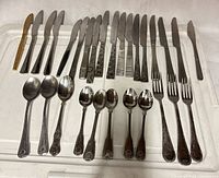 All 28 pieces laid out showing knives, spoons and forks