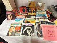 Spread of 45 RPM singles showing Joe Cocker, Connie Francis, Liberace, Diana Ross, Robert Sherman sleeves