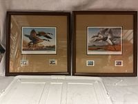 Both framed prints side by side showing artwork and stamps
