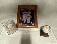 Overview with framed Yankees photo, signed baseball in cube, game-used baseball on stand