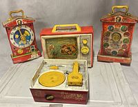 Front view of all four Fisher Price toys