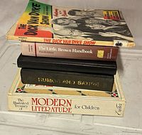 Stack of all five books showing spines and titles