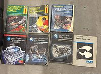 All seven automotive repair manuals arranged in two rows showing covers