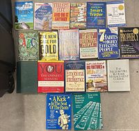 Overhead view showing all 19 hardcover and paperback books laid out in three rows