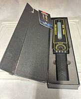 Handheld metal detector wand inside original fitted black box with foam insert