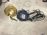 Three coiled XLR cables in yellow, blue and black
