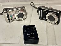 Front view of two cameras and charger