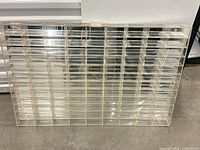 Front view of clear plexiglass display showing 108 slots