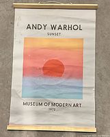 Full view of poster showing artwork, text, wood slats, hanging cord