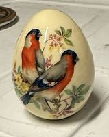 Full view of porcelain egg showing two songbirds and floral design