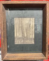 Full view of framed print showing wooden frame and mat