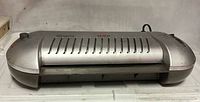 Front view of Xerox XRX-LM1910 laminator showing feed slot, vented top and power cord