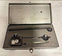 open case showing planimeter, arms, weight, tracer pin and foam insert