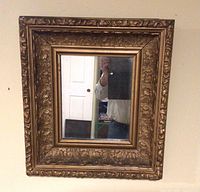 Full view of ornate rectangular mirror on wall