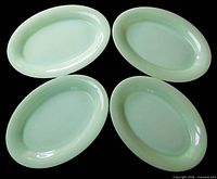 Top view of four matching jadeite platters