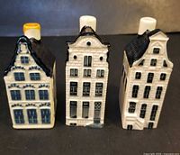 Front view of three Delft miniature houses showing façade detail