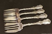 Four sterling dessert forks, full view
