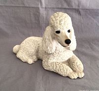 front view of white poodle sculpture