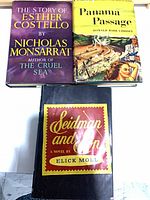 Front covers of three hardcover novels