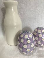 Milk bottle and two egg-shaped shakers front view