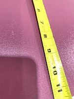 Cover with tape measure showing width about 8 inches