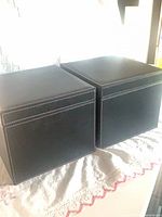 Two black faux leather boxes side by side