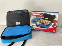 Insulated carrier open with lid inside, product box visible