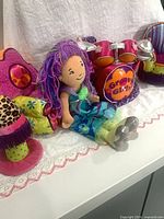 Overall view with doll, drum set, ottoman, accent chair visible