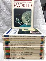 Stack of volumes 2-16 spine-out identifying titles and volume numbers