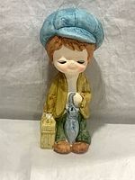 Front view of ceramic boy figurine