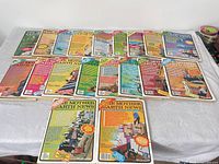 Front covers of all 23 magazines arranged on table