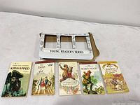 Overview of all five books with cardboard holder