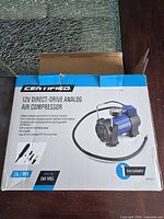 Retail box showing Certified 12V direct-drive analog air compressor