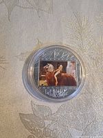 Reverse with coloured painting insert inside capsule