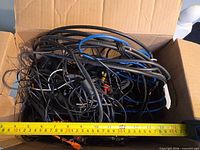 Overview of cables in box with measuring tape