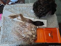 Overview of wig, straight topper, clip-in wefts, and orange Full Shine box