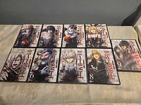 Front covers of all nine Death Note DVD volumes 1-9 laid out