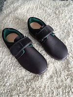 Top and side view of both shoes showing Velcro straps, uppers, and overall condition