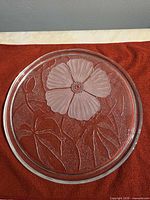 Full view of round glass platter showing floral design