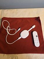 Front view of Chromecast, remote, power cable