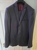 Front view of charcoal gray two-button jacket on hanger