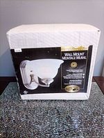 Front view of boxed Hampton Bay wall sconce showing product image and details