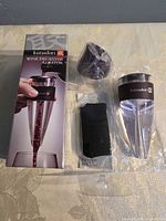 Front of retail box beside unpacked aerator components