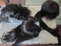 Top view of three wigs showing textures and colors