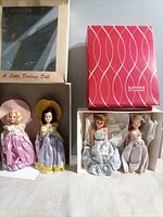 Overview showing four dolls in two boxes
