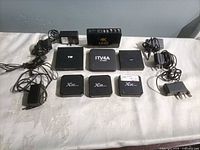Front view of all seven streaming boxes with power adapters