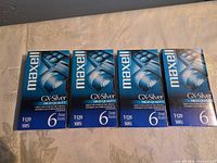Front view of four sealed Maxell GX-Silver VHS tapes