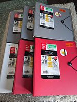 Six Mead Five Star binders in assorted colors with labels